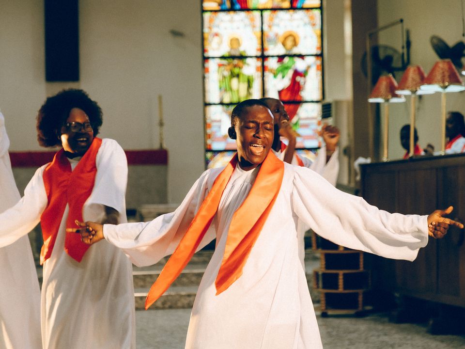 A church choir singing and dancing joyfully during a service